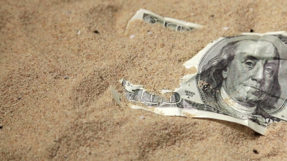 100 Dollar Bill In The Sand In The Desert