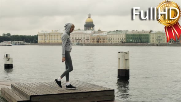 Girl Playing Sports on the Waterfront of the City