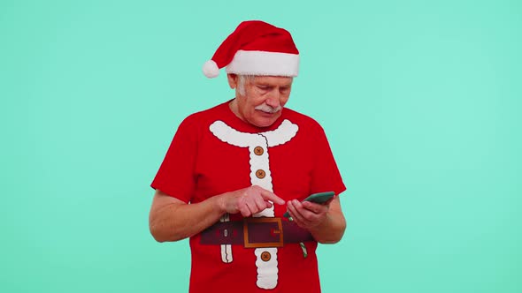 Grandfather in Christmas Tshirt Looking Smartphone Display Sincerely Rejoicing Win Success Luck