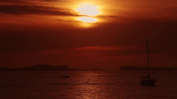 Inlfatable Motor Boat Going Past the Sunset in Ibiza