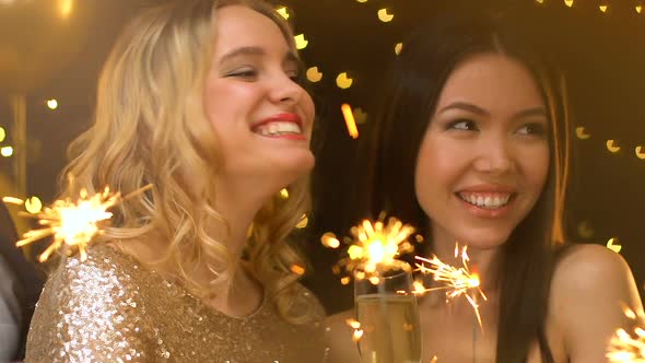 Pretty Ladies Holding Bengal Lights at Christmas Party, Laughing and Having Fun