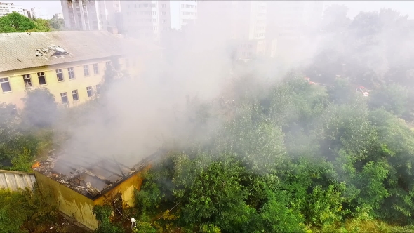 House Is On Fire - Firefighters Extinguish a Fire With Water. Aerial