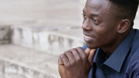 Happy american african man smiling looking at the city