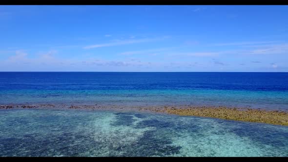 Aerial drone seascape of tranquil lagoon beach time by blue lagoon and white sandy background of a d