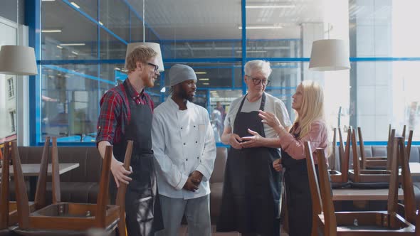 Multiethnic Restaurant Staff Talking Before Opening