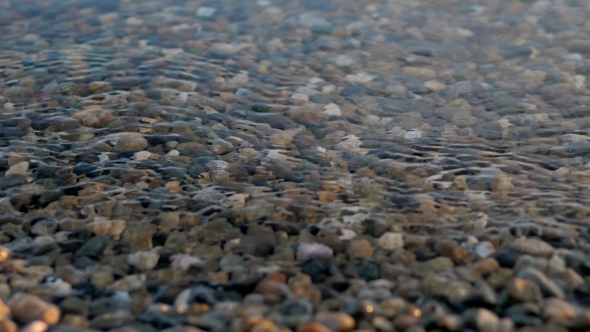 Sea Braking Against Stones And Pebbles On a Beach, Waves Of Pure Water