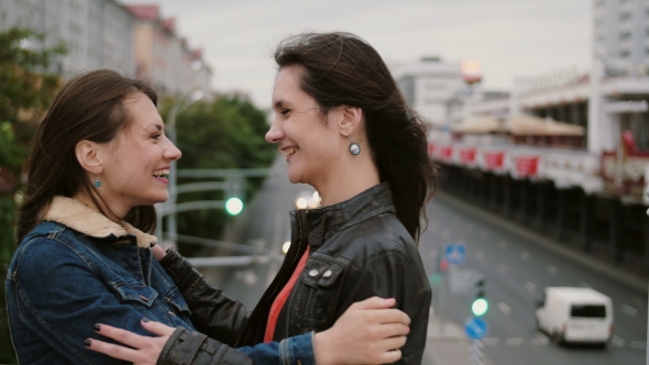 Two Beautiful Girls Best Friends Met At The City Bridge, Hugging, Kissing, Talking, Smiling