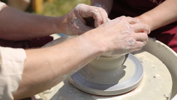 Creating a Pot On a Potter's Wheel.