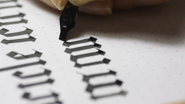 Female Hand Writes a Pen Calligraphic Signs
