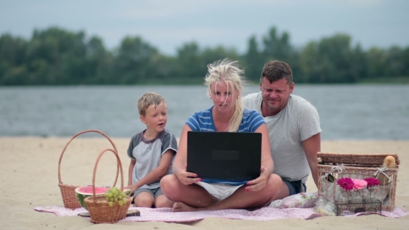 Family Using Laptop To Talk To Grandmom