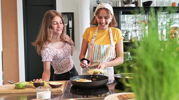 Teenage friends preparing homemade lunch in kitchen