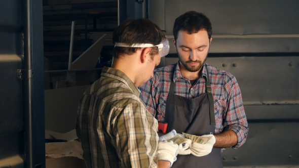 Chief Carpenter Pays His Partner In Workshop.