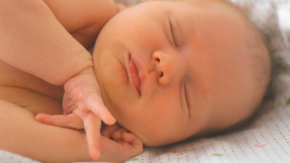 Newborn Baby Girl Stretching Herself While Sleeping