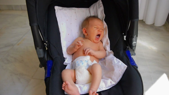 Newborn Baby Yawning In The Car Seat