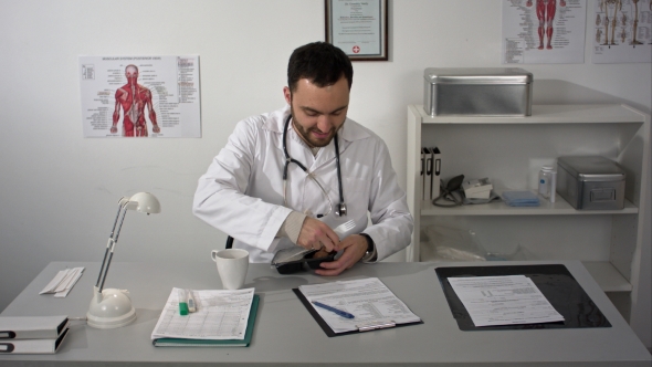 Doctor Having a Lunch At His Office During The Break. Employee Eating From Lunchbox Plastic