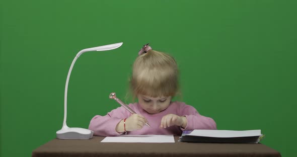 Girl Drawing at the Table. Education Process