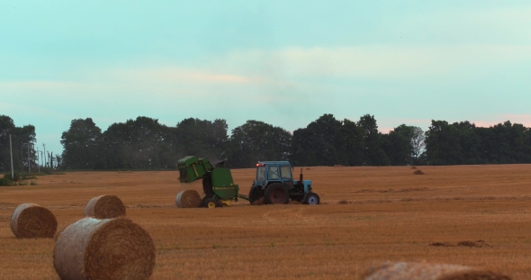Field With Straw Bales Under Sunset Sky Traktor