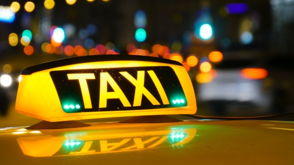 Taxi Driving With Motion Blur And City Lights.