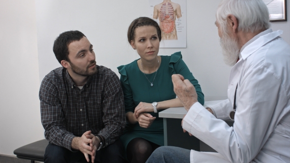 Bad News. Young Man And His Wife Together With Psychologist.