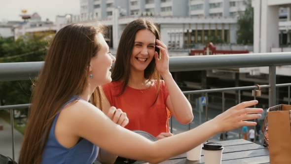 Attractive Brunette Women Drinking Coffee Communicate In a Cafe With a View Of The Traffic, Talking
