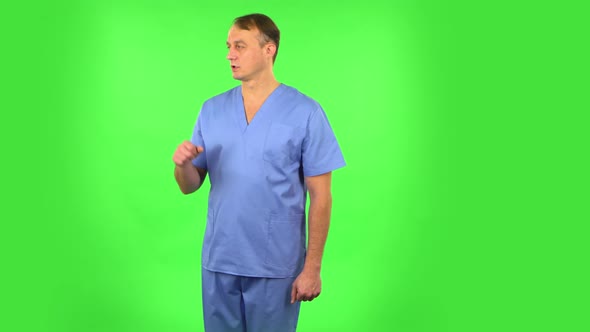 Medical Man Talking and Pointing Side Hand for Something, Copy Space. Green Screen