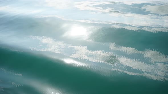 Beautiful Seascape Waves blue ocean on sun rays texture backgrounds.
