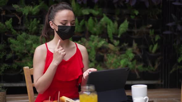 Portrait of Young Professional Business Consultant in Coronavirus Face Mask Sitting in Outdoors Cafe