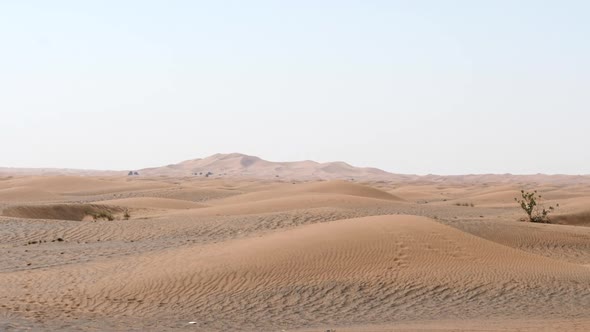 Sandy Desert Landscape With Distant Sand Dune, Sunny. Gentle Zoom In.