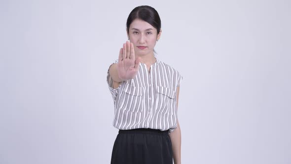 Serious Asian Businesswoman Showing Stop Gesture