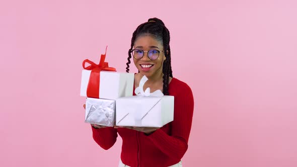 Cute Young African American Girl Holding Three Gift Boxes