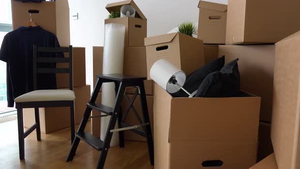 Cardboard Boxes and Chairs in the Interior of an Apartment - Closeup