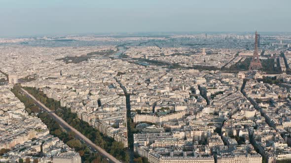 Dolly back drone shot of West Paris Eiffel tower and arc de triomphe