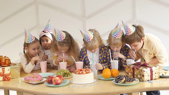 Portrait of Happy Kids Drinking Beverages at Birthday Party