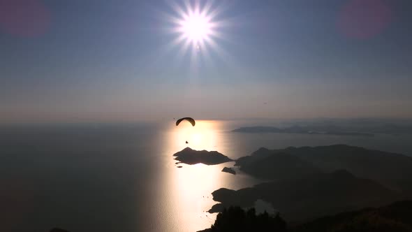 Paragliders Flying With Paragliding in Sky Over the Forest, Mountain Top and Sea
