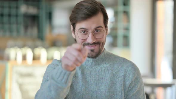 Portrait of Young Man Pointing and Inviting