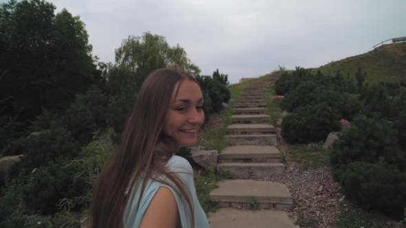 Young Girl With Long Hair Is Upstairs In The Park.