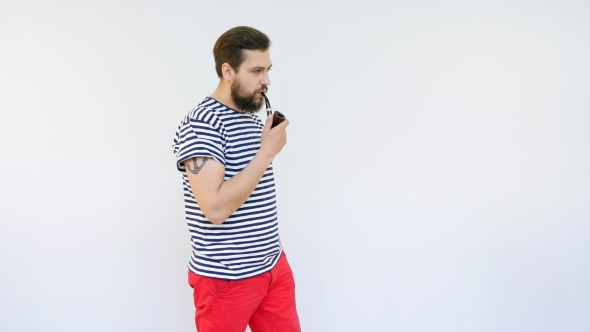 Handsome Seaman With a Beard Smoking a Pipe