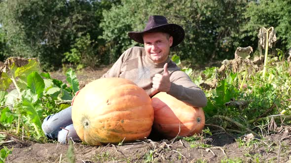 Satisfied Farmer with a Big Orange Pumpkin