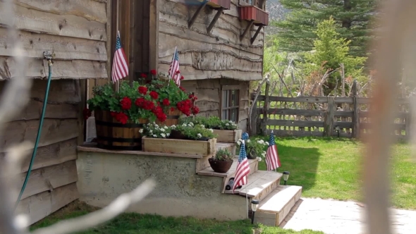 Front Porch Of Home With American Flag