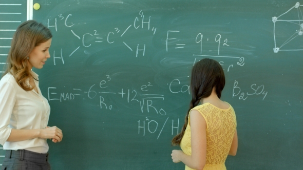 Student Writing Chemical Symbol On Blackboard alt