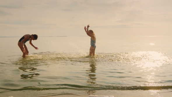 Happy Childhood - Two Girls Playing In The Water, Laughing