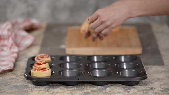 Female Hands Making Buns with Berry Jam.