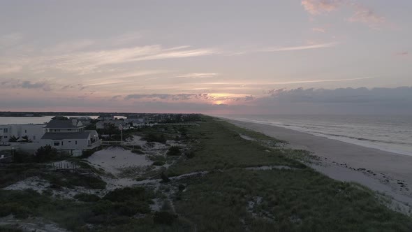 Pedestal Shot of the Sunset Over Houses and the Beach in the Hamptons