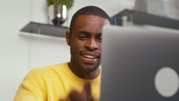 Young student calling with webcam at the desk at home office