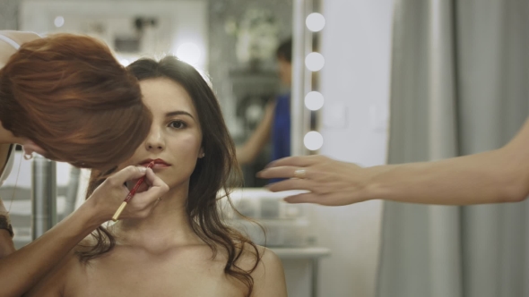 Professional Make Up Artist Working On a Model - Pin Up Style