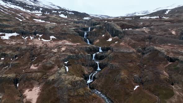 Pullback Over Series Of Waterfall At Klifbrekkufossar In Mjoifjordur River, Eastern Iceland. Aerial