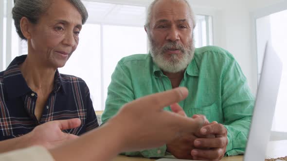 Mature couple with advisor at home