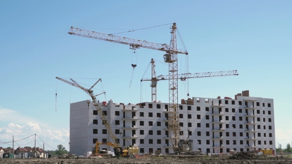 Construction Cranes Works On The Construction Site