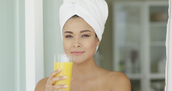 Smiling Healthy Young Woman Drinking Orange Juice