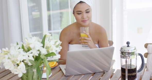 Woman In Towel With Laptop Having Breakfast